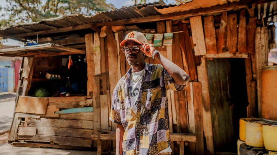 Stylish Man in Colorful Shirt Outside Rustic Nairobi Hut